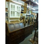A large furniture lot comprising a pair of mirror veneered bedside tables, a bureau cupboard, a