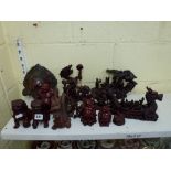 A collection of Oriental resin red lacquer figurines of temple lions, dragons, figures, Buddhas,
