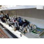 A large quantity of novelty cat figurines including Bretby, two sets of fireside cats, Royal
