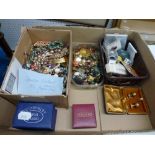 A shoebox and album of postcards, a plastic crate of loose stamps, a framed First Day Cover, a small