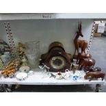 Two wooden mantel clocks, wooden carved decorative animals including elephants and rhinoceros, three