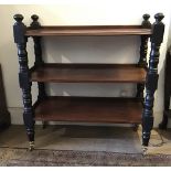 A Victorian mahogany three-tier buffet, on ebonized turned supports and castors, 99 x 42 x 106 cm [