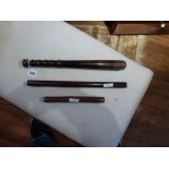 A vintage Metropolitan Police truncheon, 38 cm long, and two parallel rules (3) [This lot is