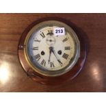 A mahogany mounted vintage brass marine bulkhead clock with 16 cm diameter dial with Roman