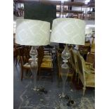 A pair of stylish modern floor standing glass standard lamps with matching cream floral shades WE DO