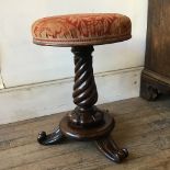 An early Victorian rosewood tripod piano stool with overstuffed revolving seat, 34 cm diameter x