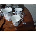 A set of three early 18th century Chinese porcelain famille rose graduated baluster tankards, the
