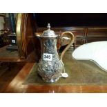 A fine George III silver hot water jug, in crisp condition, of baluster shape embossed and chased