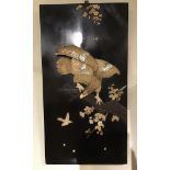 An inlaid Japanese lacquered panel of an eagle in carved bone chasing a bird, circa 1900, 49 x 90 cm