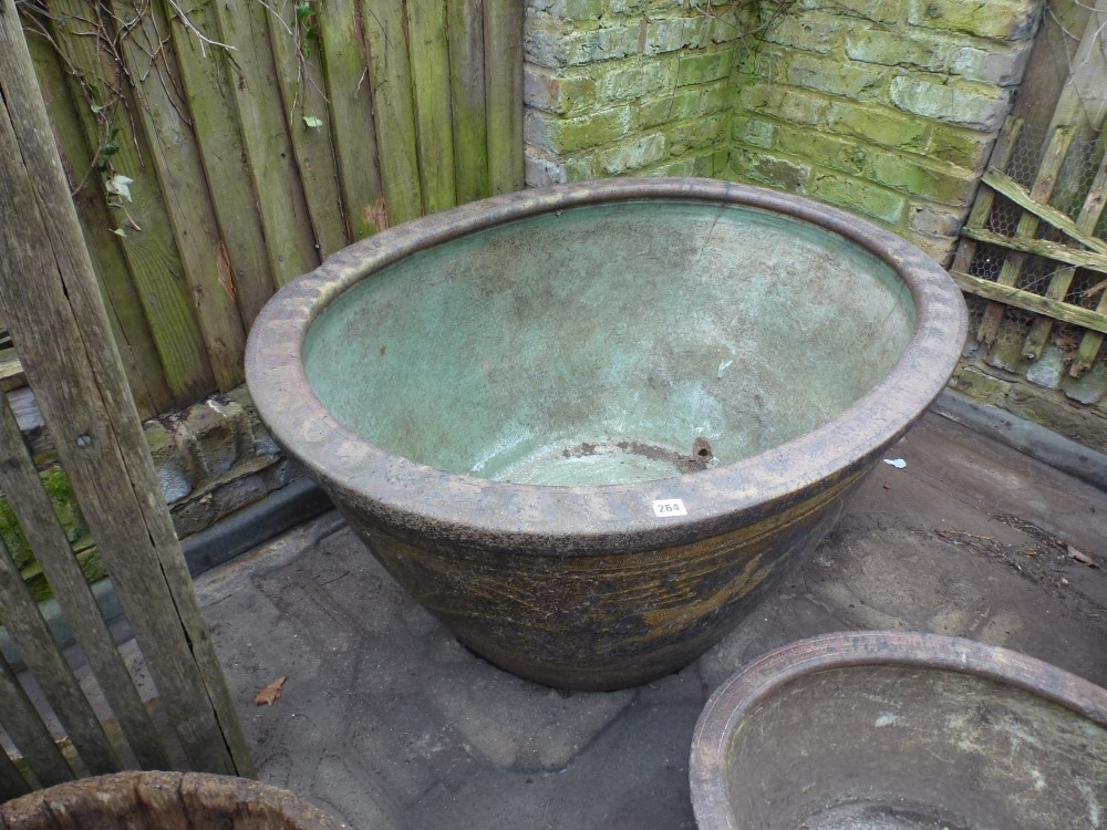 A massive antique Chinese oval stoneware fish bowl, the exterior with slipware bird and flower