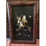 A Japanese lacquered panel depicting an eagle carved in bone chasing birds, with mother-of-pearl