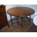 A late 17th century and later yew wood oval drop-leaf table with end drawer, raised on slim