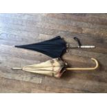 Two vintage parasols, one with carved ivory handle, the other with raffia-work canopy [This lot is