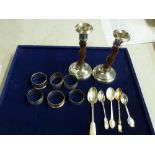 A pair of George V candlesticks in oak and silver, five silver napkin rings, an Egyptian niello-