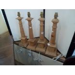 A set of four turned wood table lamp bases, 42 cm high [This lot is viewed at and cleared from