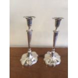 A pair of Edwardian filled silver table candlesticks, shaped oval, complete with nozzles, 29 cm,
