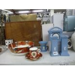 A pair of Wedgwood Millennium candlesticks in pale blue jasper ware with a matching clock and a