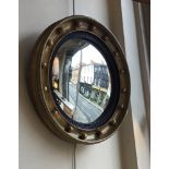 An English gilt-framed circular convex mirror, the plate 28 cm diameter [This lot is viewed at and