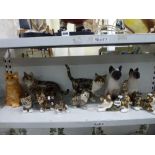 A collection of eleven Mike Hinton Winstanley pottery cat figurines including two Siamese and a