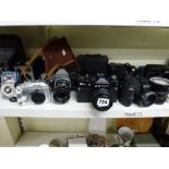 A camera lot comprising of a folding camera, a Zenit 12XP, a Praktica LB, a Fuji film Finepix, an