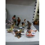 Eleven various bird figurines including a Royal Crown Derby pheasant, a Beswick chaffinch no. 991, a