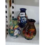 Three vintage Moorcroft small vases, one in Orchid, Slipper Orchid and Blossom pattern, signature