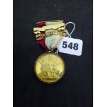 A Masonic Honourable Testimonial medal with 9 ct gold mount, on ribbon with 1960 and 1980 bars,