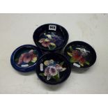 Four pieces of vintage Moorcroft in Orchid pattern, comprising three bowls, 4.5 - 5.3 in diameter,