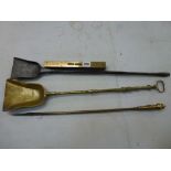 A wrought iron fire shovel, possibly 18th century Scottish, an antique brass fire shovel, a brass