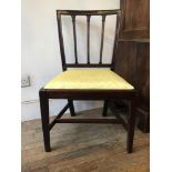 A George III mahogany dining chair, moulded stick back over upholstered drop-in seat, on square-