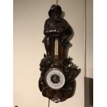 A carved 19th century Black Forest barometer depicting a fisherman with catch, 30 x 65 x 5 cm [