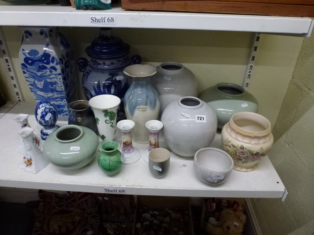 A shelf of pottery vases and jars plus a blue and white egg ornament, two pairs of china