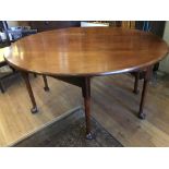 A good George III red walnut drop-leaf oval table on pad feet, open 120 x 142 x 73, closed 60 x