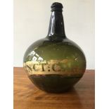 An early 19th century green apothecary bottle. A/F crack to back, 28 high x 20 cm diameter [This lot