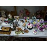 Two shelves of mixed items comprising bird figurines including Goebels, flower ornaments including