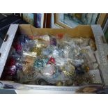 A fruit carton containing a large quantity of costume jewellery each piece well-presented within its