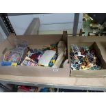 A mixed collection of die cast model vehicles, other toys, and model cowboys, soldiers and