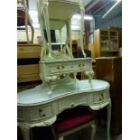 Glamorous French-style bedroom furniture in cream and gilt comprising a kidney shaped mirrored