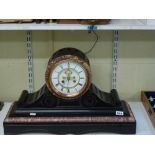 A handsome late 19th century French mantel clock in slate and marble of drum form on scrolled