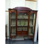 A late Victorian mahogany display cabinet, the break-front with a central glazed and marquetry