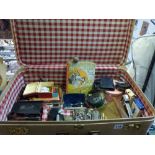 A suitcase of interesting items including old pipes, pince nez, an old monocle, fishing reel, pen