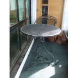 A metal patio set comprising of a circular table and two chairs [hall] WE DO NOT ACCEPT CREDIT