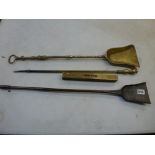 A wrought iron fire shovel, possibly 18th century Scottish, an antique brass fire shovel, a brass