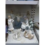 Nao porcelain, comprising: five figures, a group of playful puppies, a duckling, and a group of