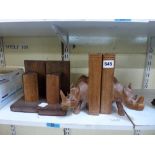 A pair of African carved wood rhinoceros bookends, and a pair of vintage bookends in the form of