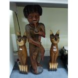 A pair of floor standing carved wooden cats and an African carved wooden floor standing figurine