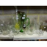 Two shelves of glassware comprising avocado dishes, vases, fruit bowls, jugs, four red overlaid wine