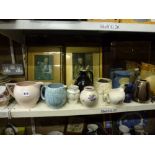 Two shelves of mixed china, mirrors and prints, including 1930s jugs, Poole Pottery vase, decorative