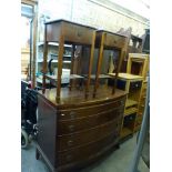 A reproduction Georgian style bow-fronted mahogany chest of four long drawers on splayed bracket