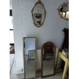 Four gilt framed mirrors comprising of a 1930s oval mirror plus another and two long dressing